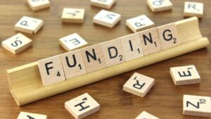 scrabble letters spelling FUNDING