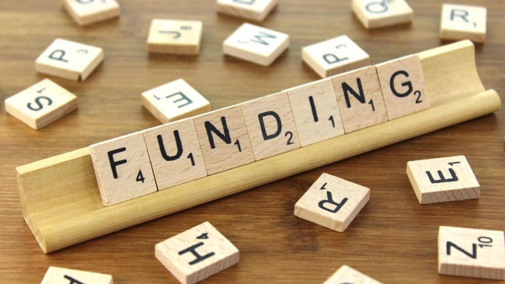 scrabble letters spelling FUNDING